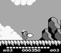 une photo d'Ã©cran de Adventure Island 2 - Aliens in Paradise sur Nintendo Game Boy